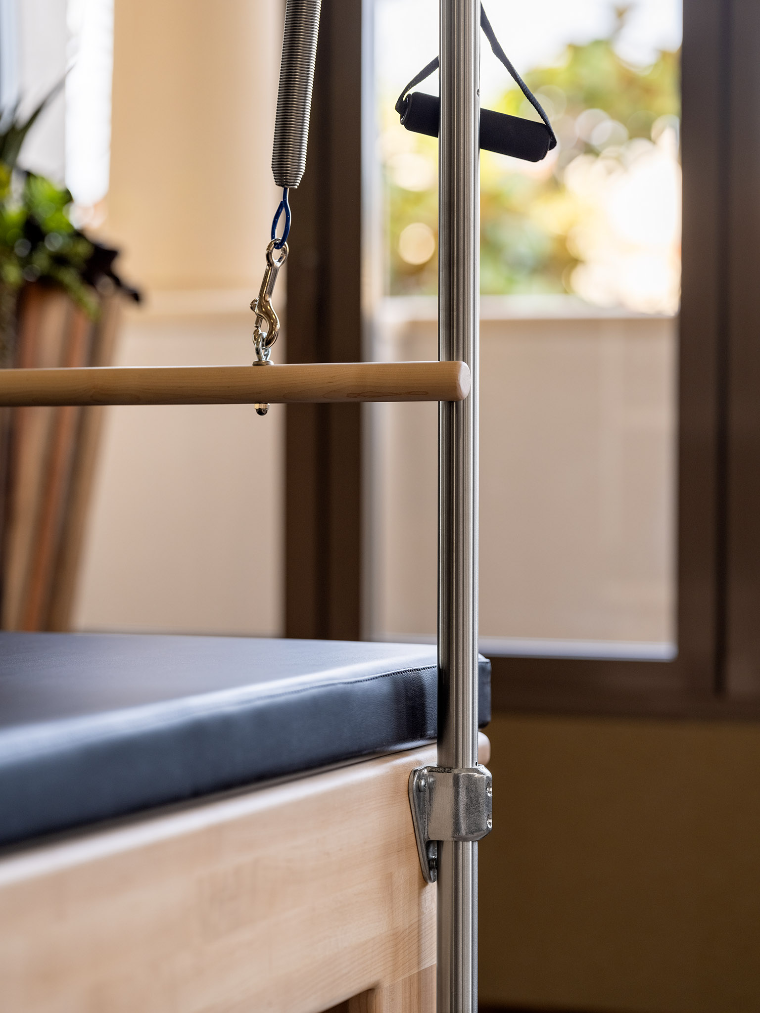 Close-up of a Pilates reformer machine.