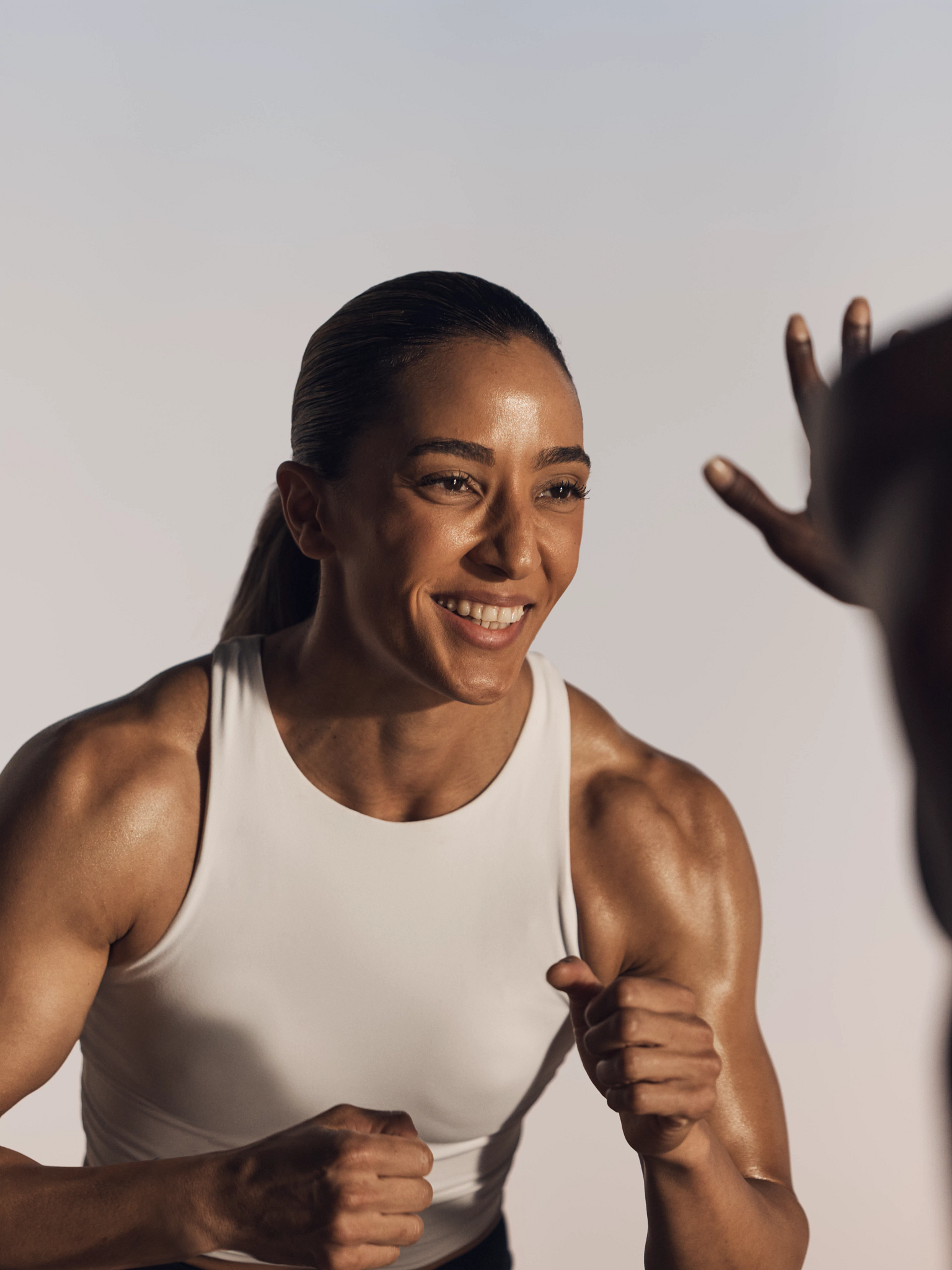 Smiling strike kickboxing martial arts class participant in ready stance at Life Time