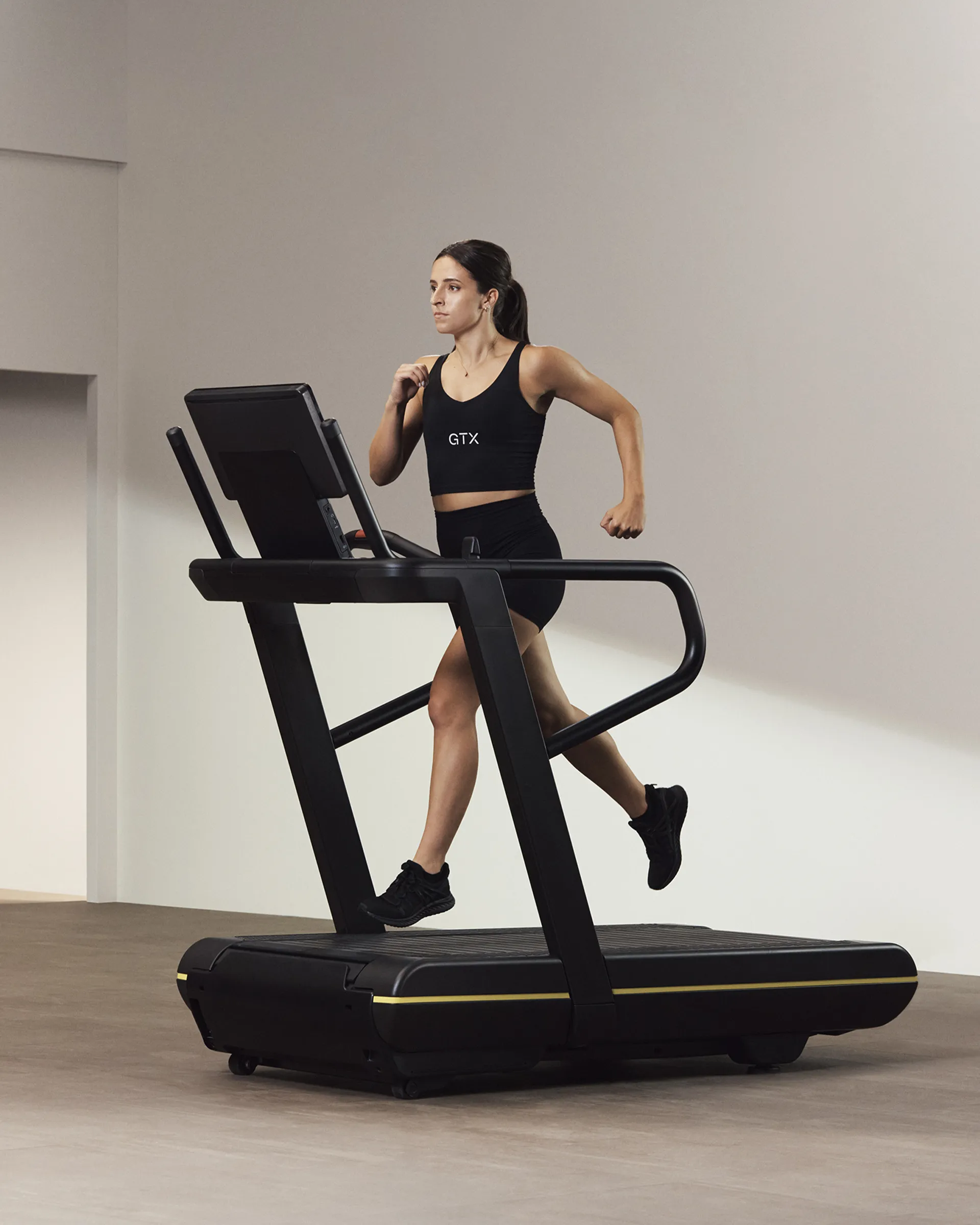 A Life Time Member running on a treadmill.